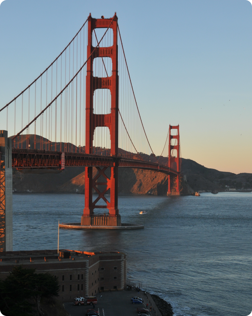 A striking red bridge connects two landmasses.